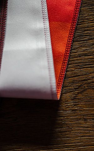Close-up of a flatlock seam joining white and red fabric