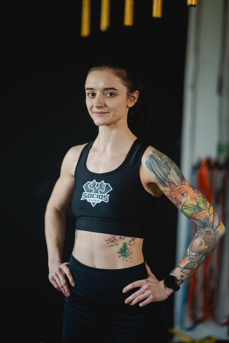 Athlete in a black Socios Silesia sports top